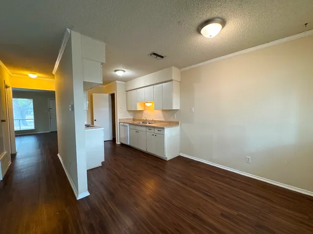 a view of a kitchen with wooden floor and a kitchen