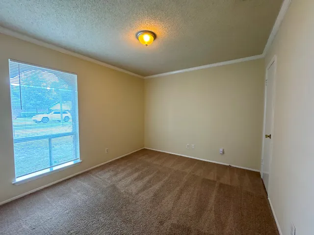 an empty room with a fireplace and painted walls