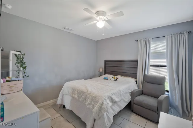 a bedroom with a bed and a couch