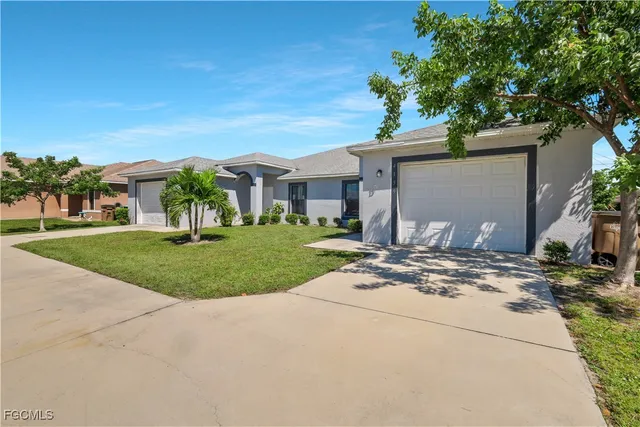 a view of a house with a tree in a yard