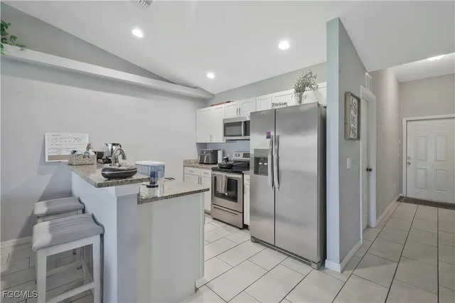 a kitchen with a sink appliances and cabinets