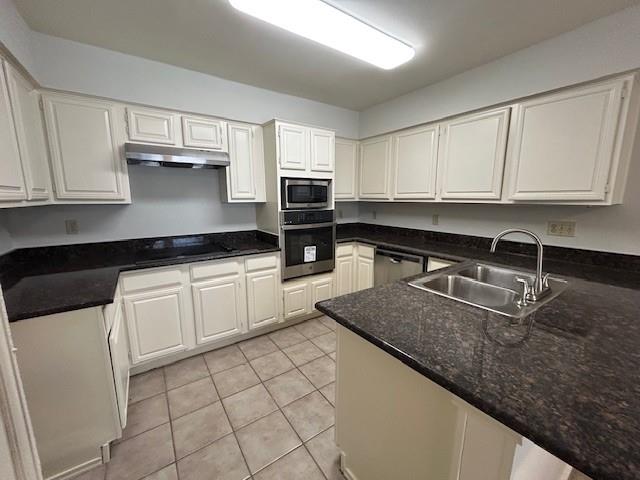 a kitchen with granite countertop a sink a stove and cabinets