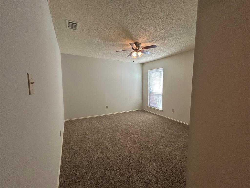3910 St Christopher Lane Dallas, TX 75287 - Photo 12 of 20 an empty room with windows and fan