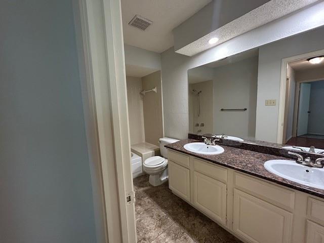 3910 St Christopher Lane Dallas, TX 75287 - Photo 14 of 20 a bathroom with a double vanity sink toilet and a mirror