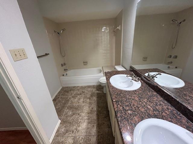 3910 St Christopher Lane Dallas, TX 75287 - Photo 15 of 20 a bathroom with a granite countertop sink a mirror a bathtub and shower