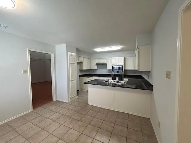 a kitchen with stainless steel appliances a sink stove and cabinets