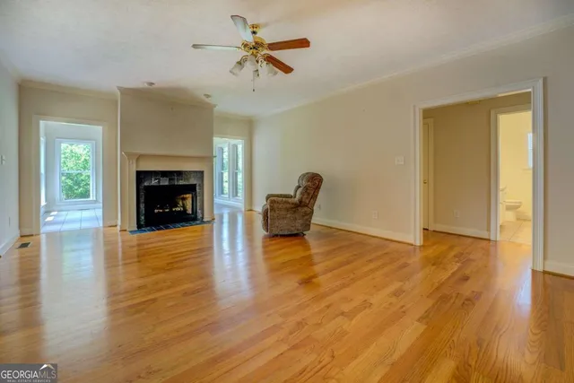 a living room with a fireplace and wooden floor