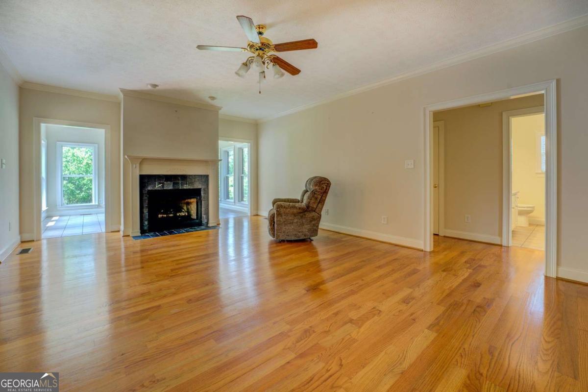 212 Willow Ridge Lane Jackson, GA 30233 - Photo 12 of 45 a living room with a fireplace and wooden floor