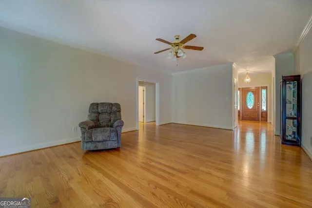 a empty room with couch and wooden floor
