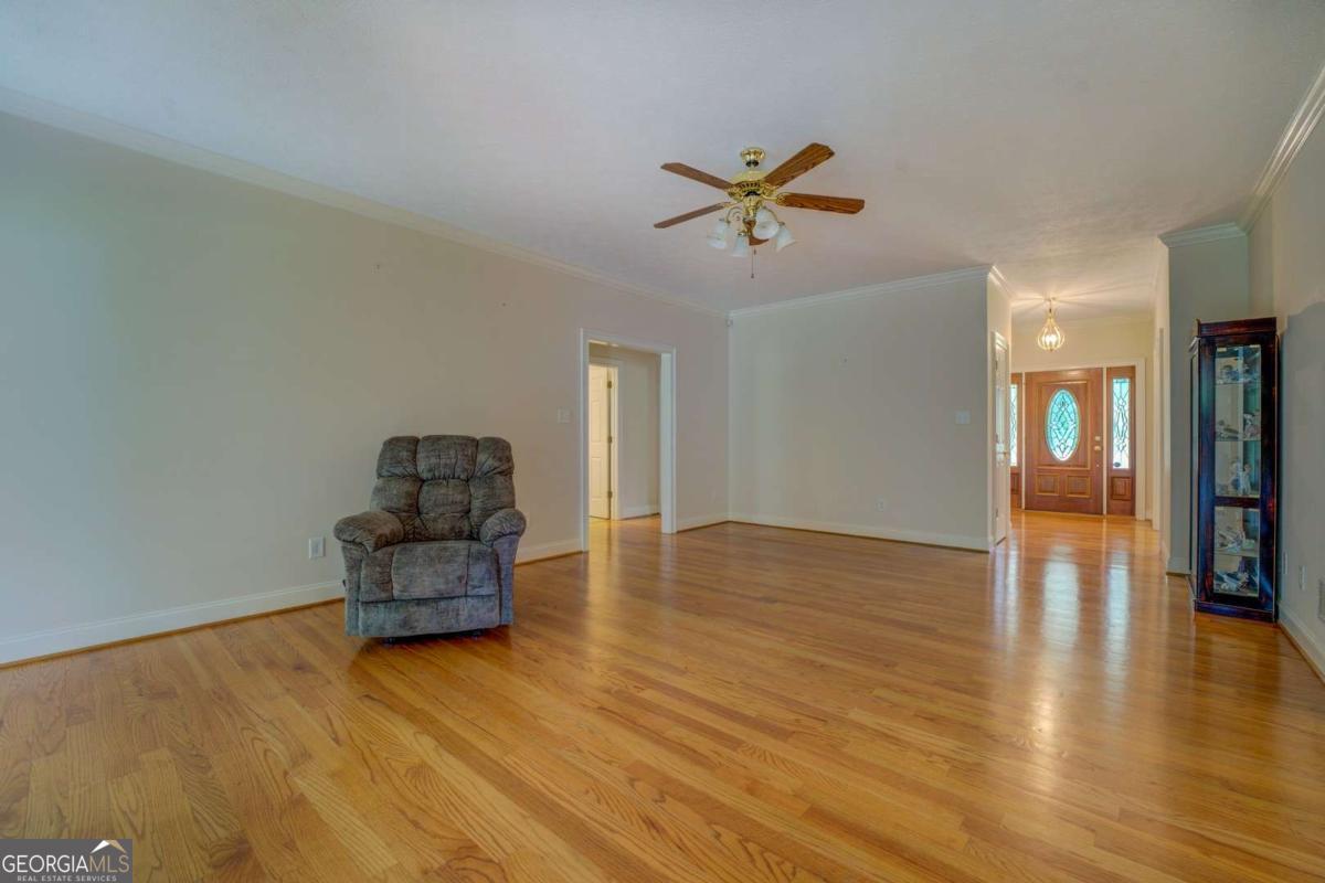 212 Willow Ridge Lane Jackson, GA 30233 - Photo 13 of 45 a empty room with couch and wooden floor