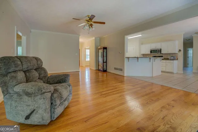 a living room with furniture and kitchen view