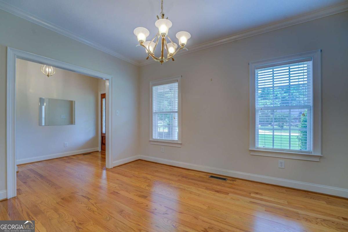 212 Willow Ridge Lane Jackson, GA 30233 - Photo 20 of 45 a view of an empty room with wooden floor and a window