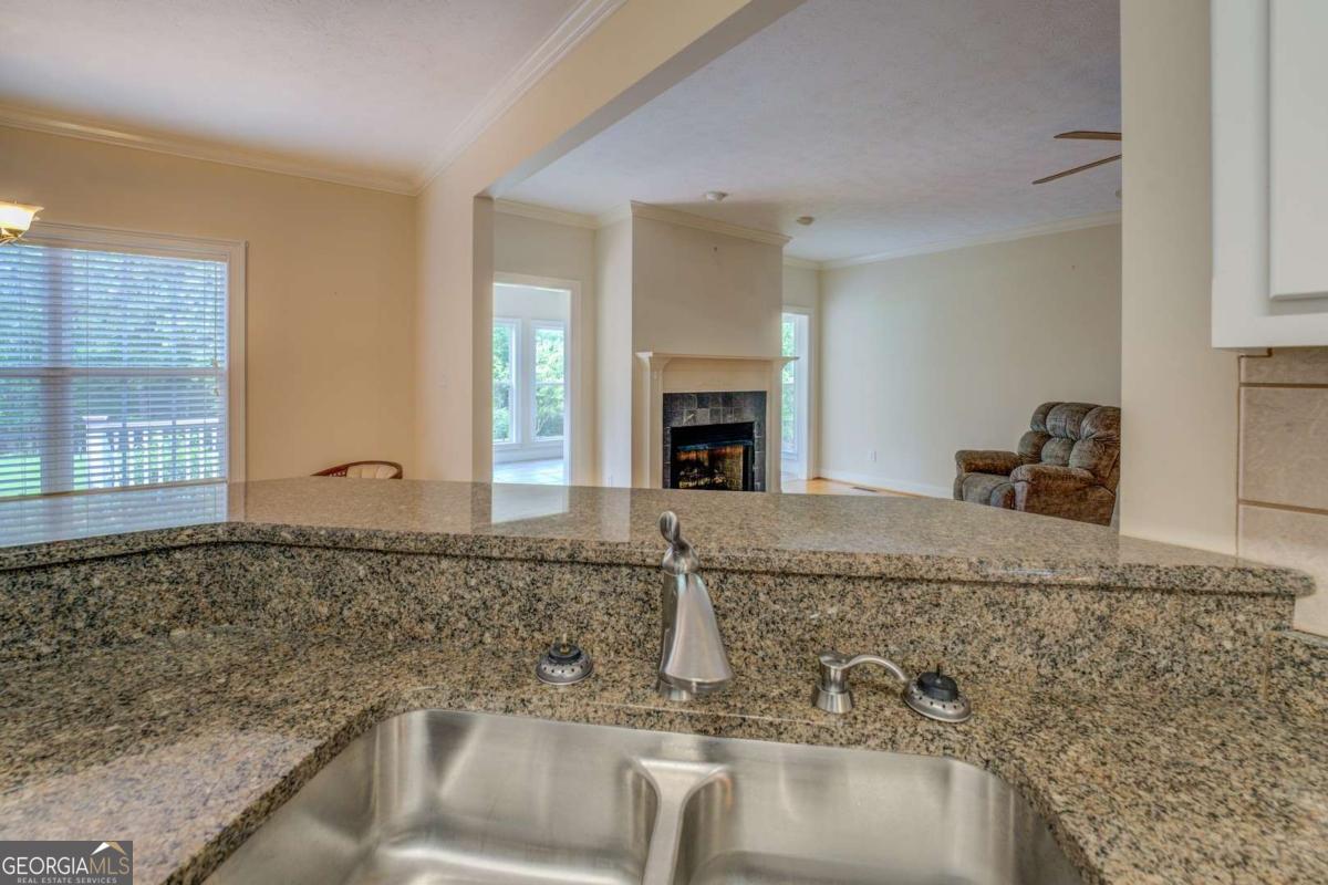 212 Willow Ridge Lane Jackson, GA 30233 - Photo 24 of 45 a kitchen with granite countertop a sink and a stove top oven
