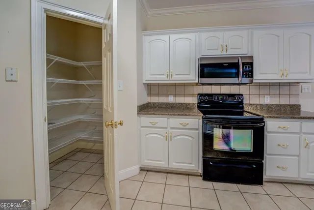 a kitchen with cabinets and appliances