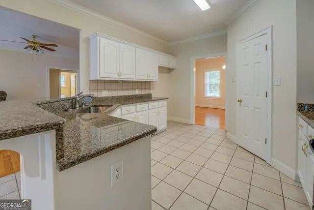 a kitchen with stainless steel appliances granite countertop a sink and cabinets