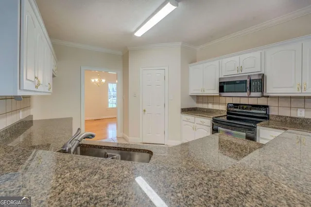 a kitchen with sink and cabinets