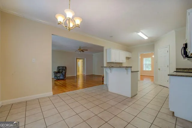 a view of a kitchen with a sink and cabinets