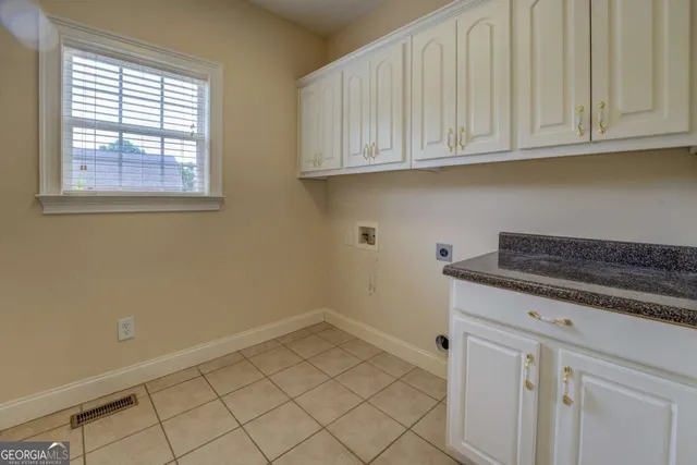 a view of a storage and utility room with window