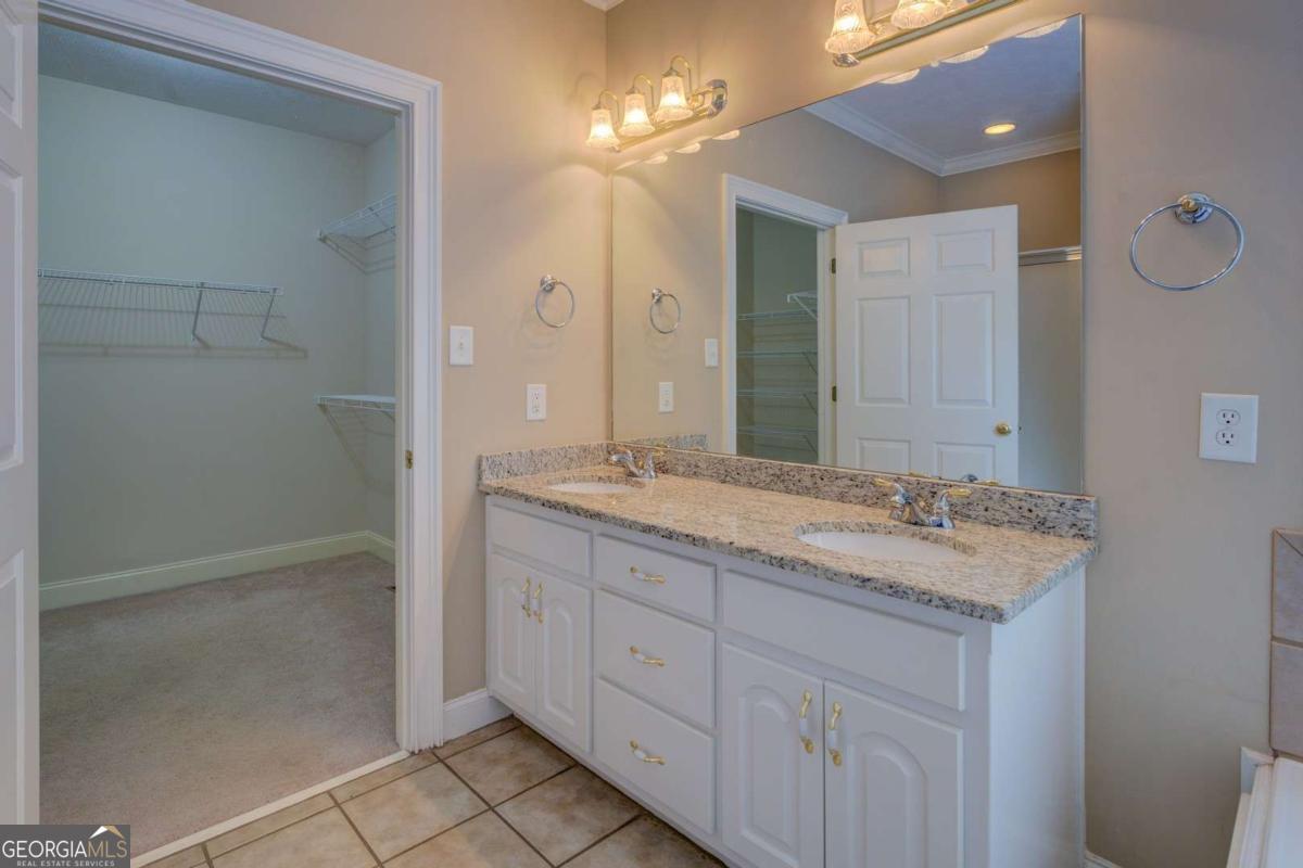 212 Willow Ridge Lane Jackson, GA 30233 - Photo 35 of 45 a bathroom with a granite countertop sink a mirror and a shower