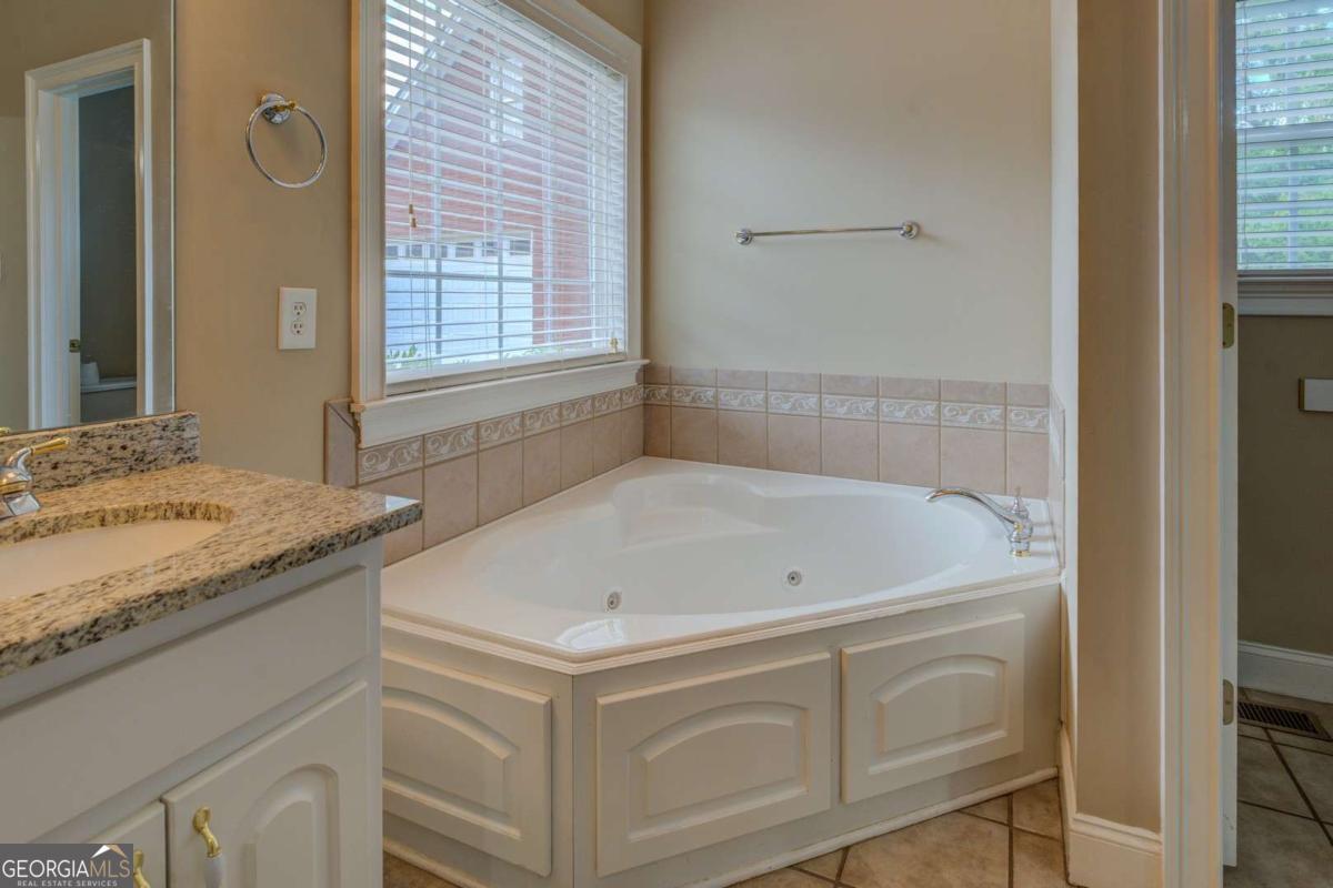 212 Willow Ridge Lane Jackson, GA 30233 - Photo 36 of 45 a bath tub sitting next to a granite countertop sink