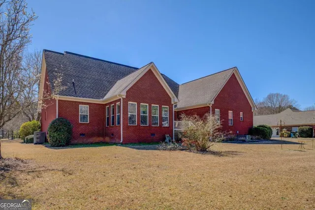 front view of a house next to a yard