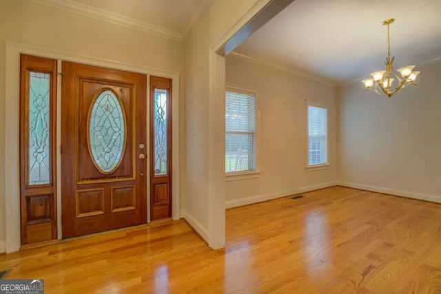 a view of an empty room with window and bathroom