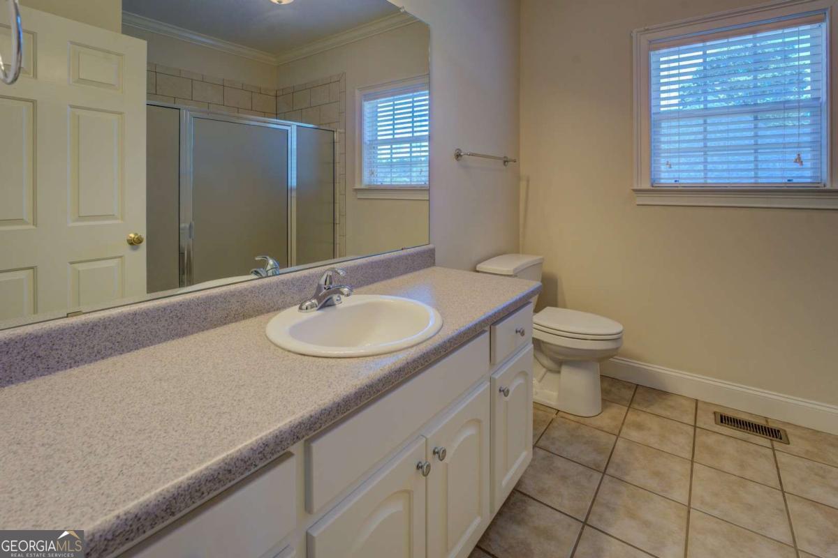 212 Willow Ridge Lane Jackson, GA 30233 - Photo 9 of 45 a bathroom with a sink toilet and window