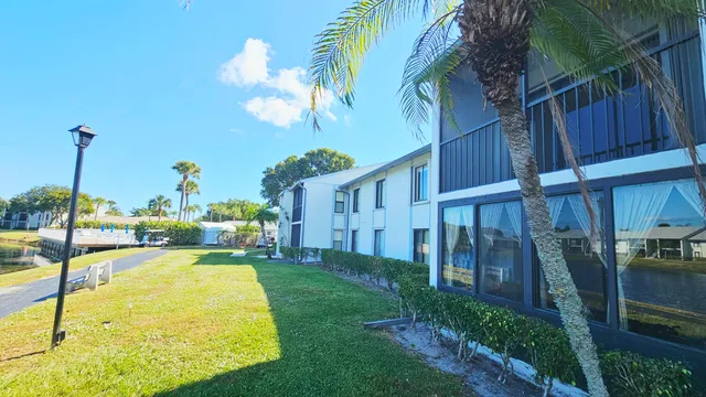 a view of a house with backyard and sitting area