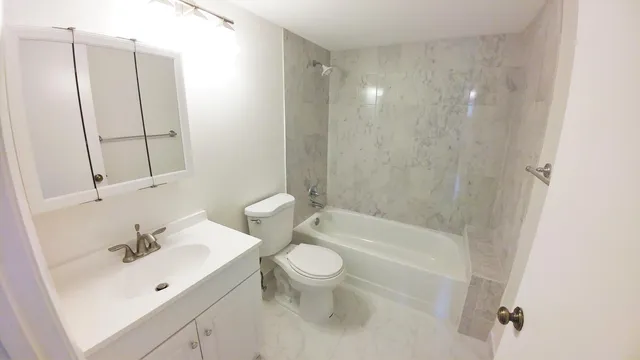 a kitchen with refrigerator and cabinets