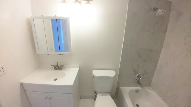 a kitchen with a refrigerator sink and cabinets