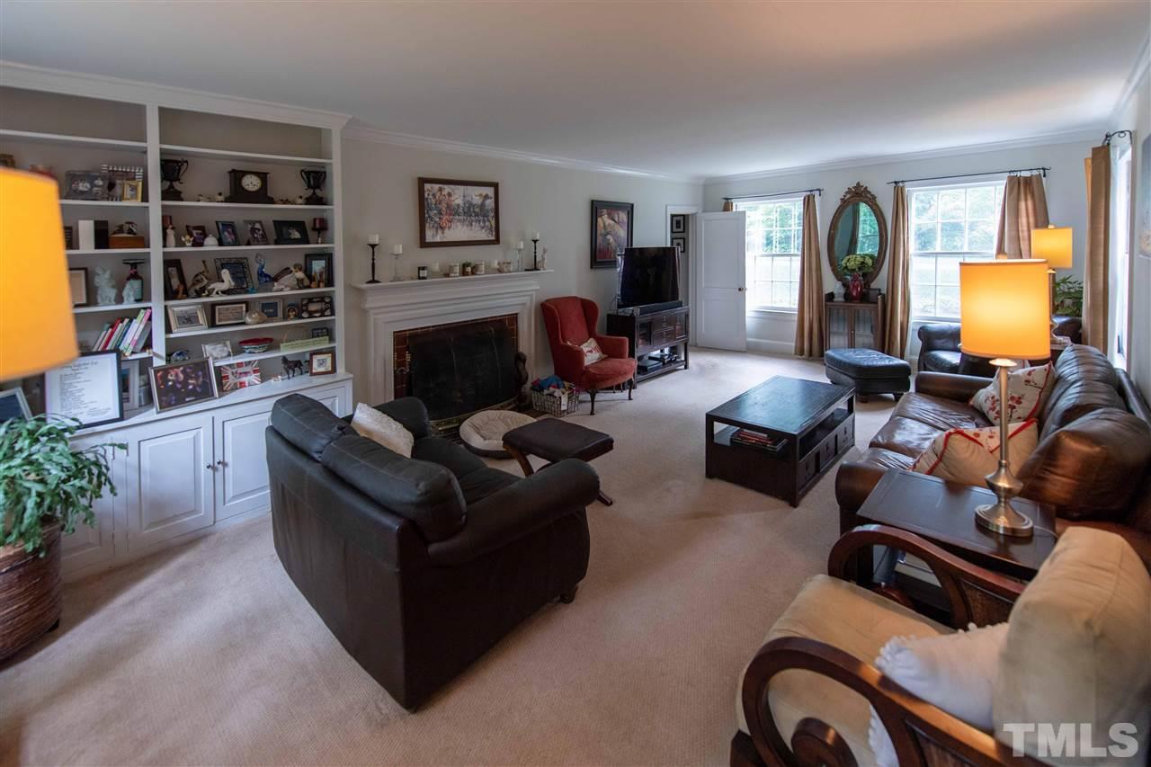 3113 Darien Drive Raleigh, NC 27607 - Photo 3 of 3 a living room with furniture windows and a fireplace