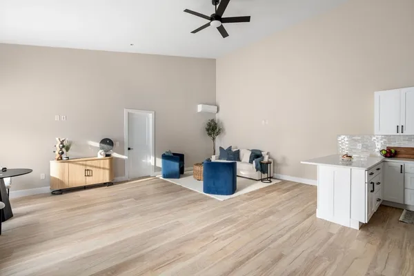 a living room with furniture and a wooden floor