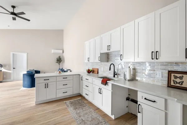 a kitchen with cabinets and window