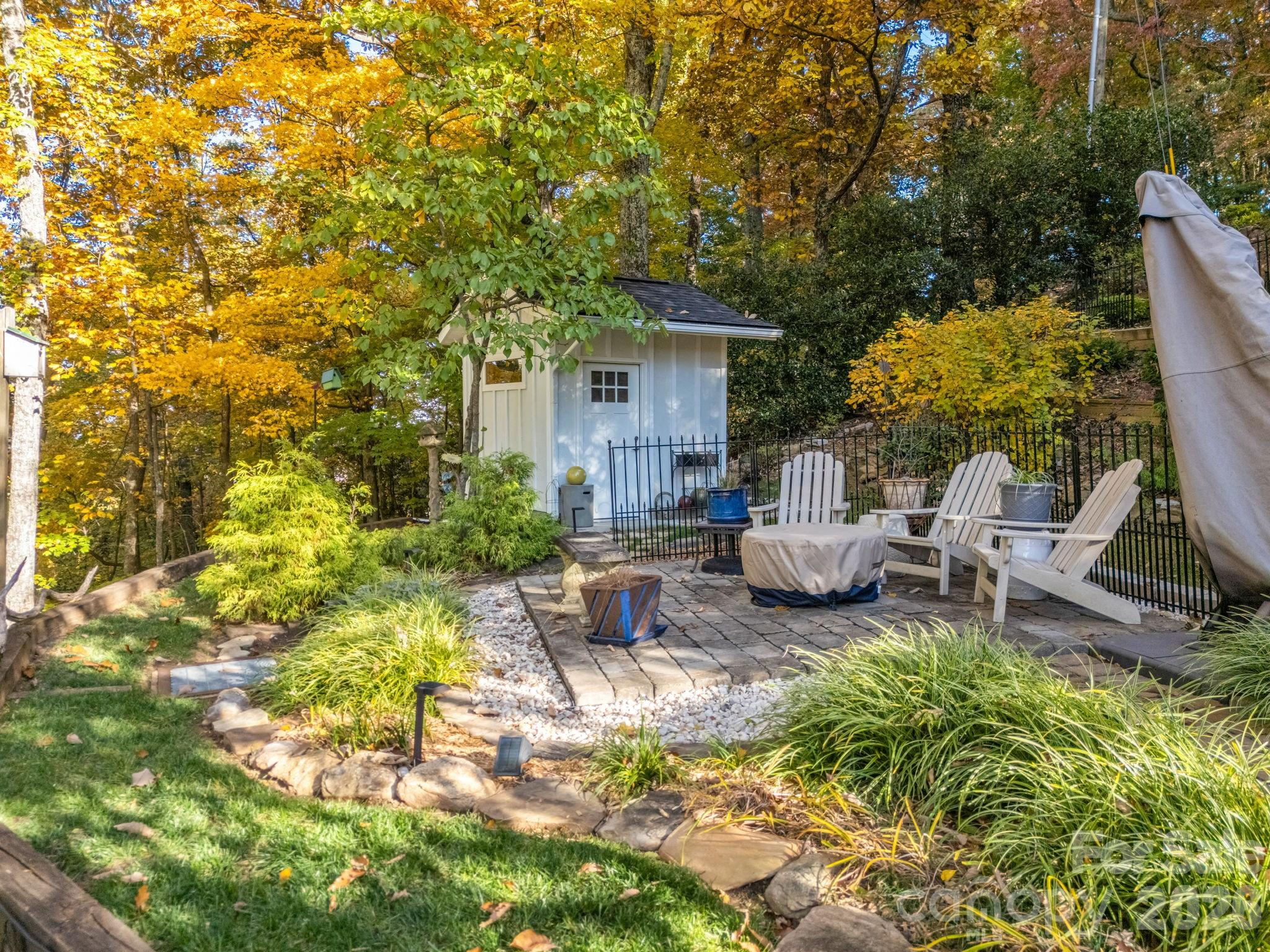 200 Piney Mountain Road Tryon, NC 28782 - Photo 42 of 48 a view of a patio with table and chairs and potted plants