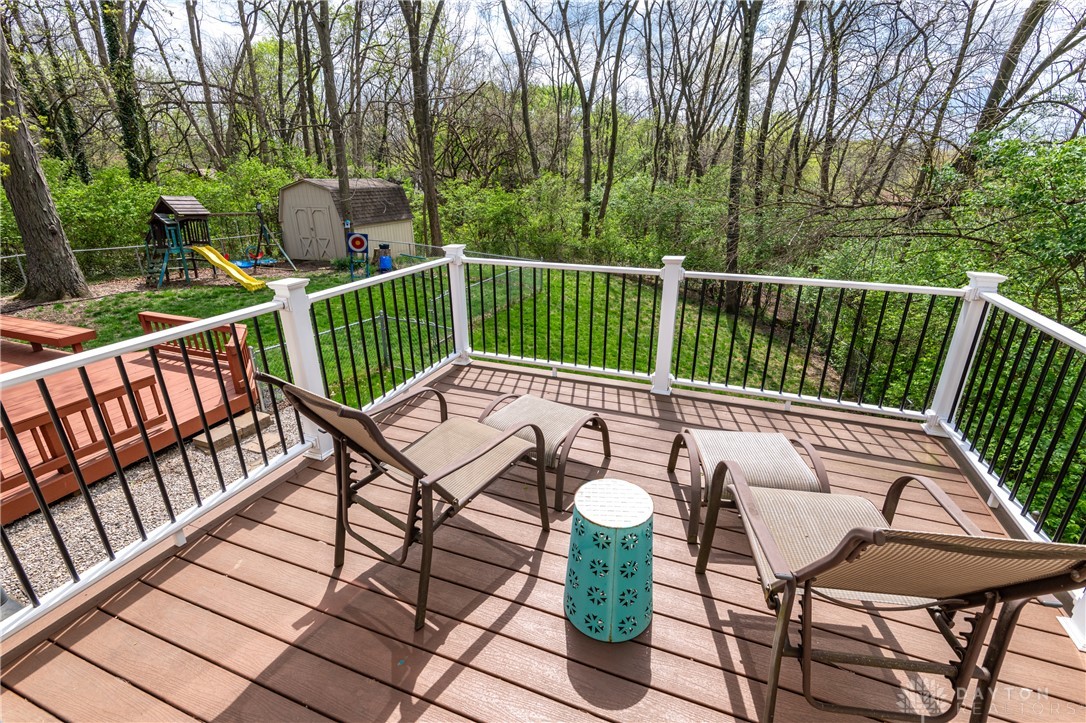 728 Chipplegate Drive Centerville, OH 45459 - Photo 18 of 30 This spacious wooden deck offers elevated outdoor relaxation overlooking a lush, verdant backyard.