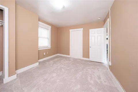 an empty room with windows and closet