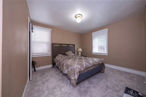 a bed sitting in a bedroom next to a window