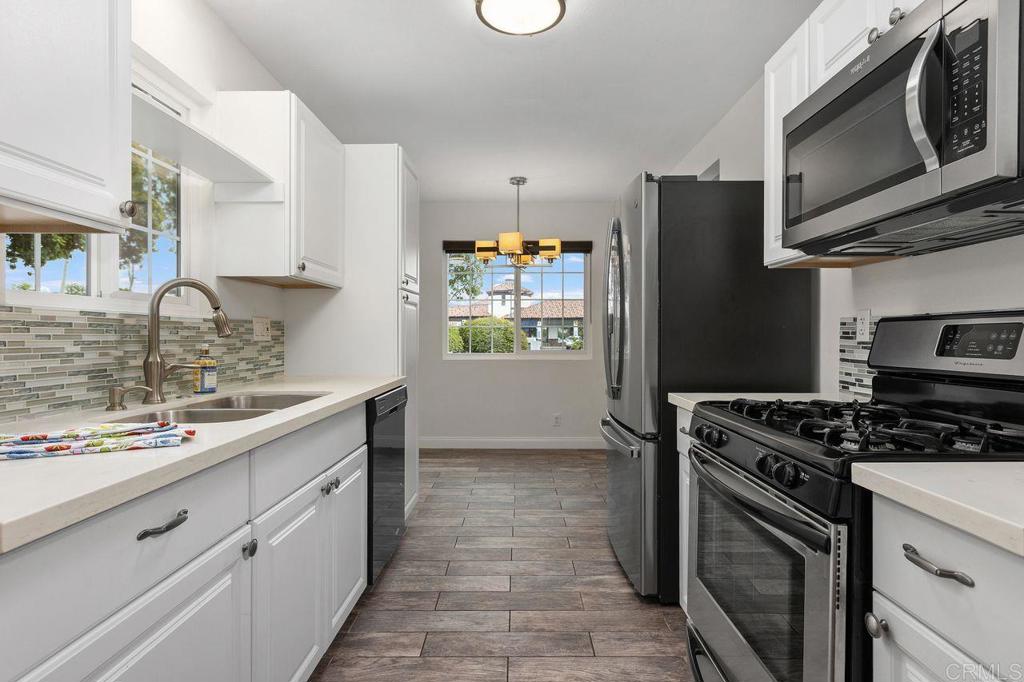 3518 Capalina Road San Marcos, CA 92069 - Photo 15 of 34 a kitchen with stainless steel appliances granite countertop a stove a refrigerator and a sink