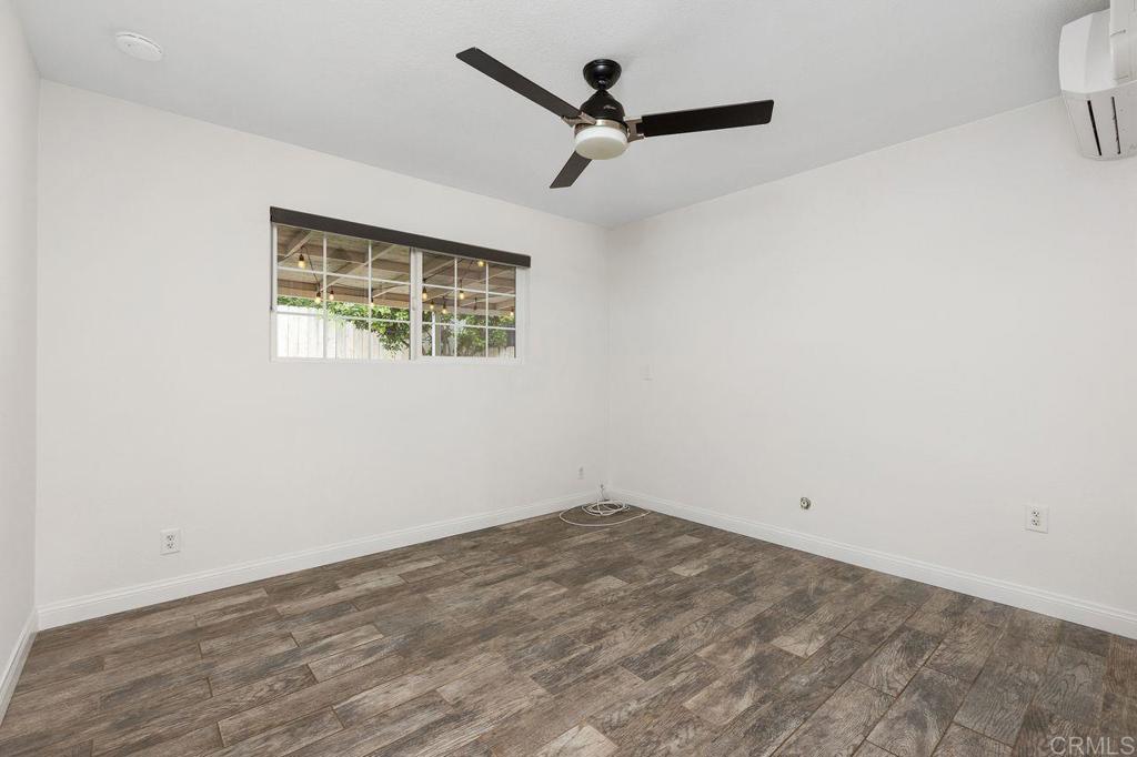 3518 Capalina Road San Marcos, CA 92069 - Photo 21 of 34 a view of a big room with wooden floor and a ceiling fan