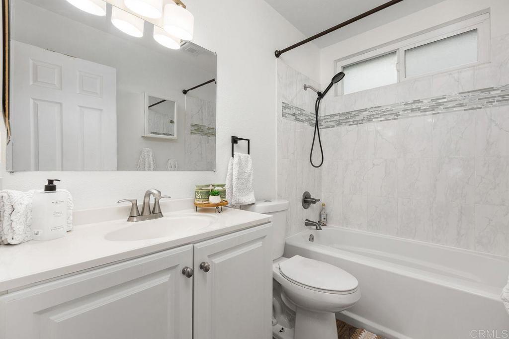 3518 Capalina Road San Marcos, CA 92069 - Photo 22 of 34 a bathroom with a sink a toilet and a bathtub
