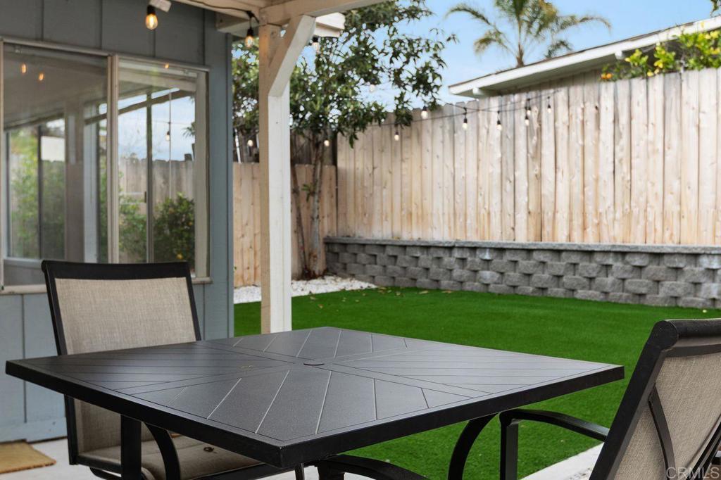 3518 Capalina Road San Marcos, CA 92069 - Photo 29 of 34 a view of a backyard with table and chairs with wooden floor and fence