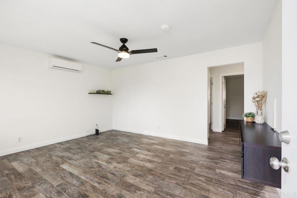 3518 Capalina Road San Marcos, CA 92069 - Photo 7 of 34 a view of a livingroom with wooden floor and a ceiling fan