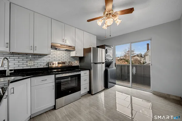 a kitchen with stainless steel appliances granite countertop a stove and a refrigerator