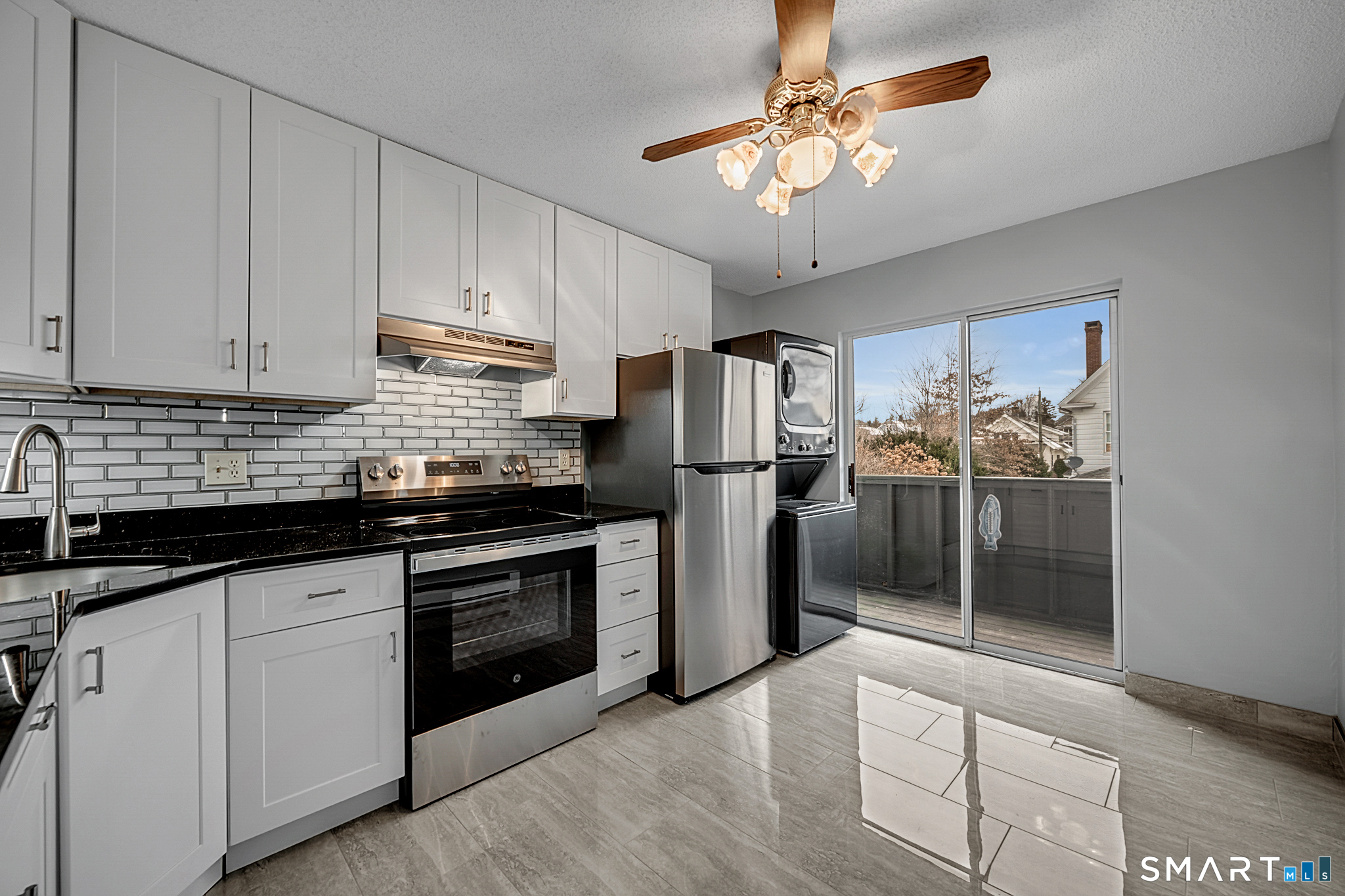 81 Chipman Street, Unit 13 Waterbury, CT 06708 - Photo 2 of 11 a kitchen with stainless steel appliances granite countertop a stove and a refrigerator