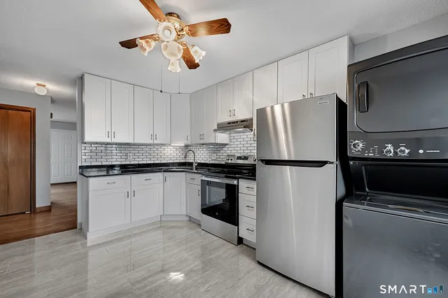 a kitchen with stainless steel appliances a refrigerator sink and microwave