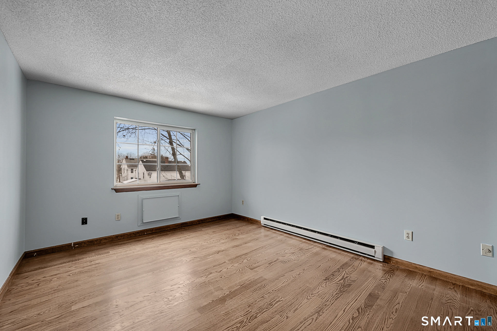 81 Chipman Street, Unit 13 Waterbury, CT 06708 - Photo 5 of 11 an empty room with windows