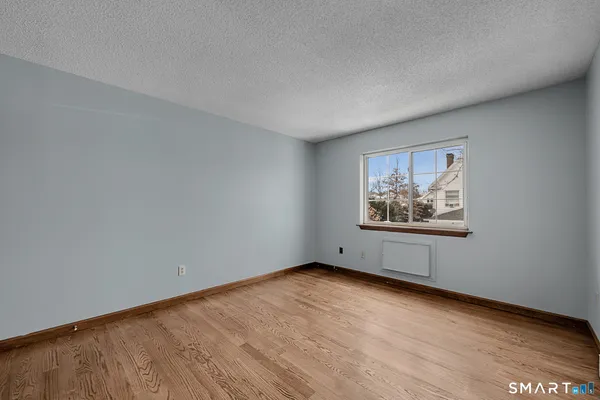 a view of an empty room with a painting on the wall