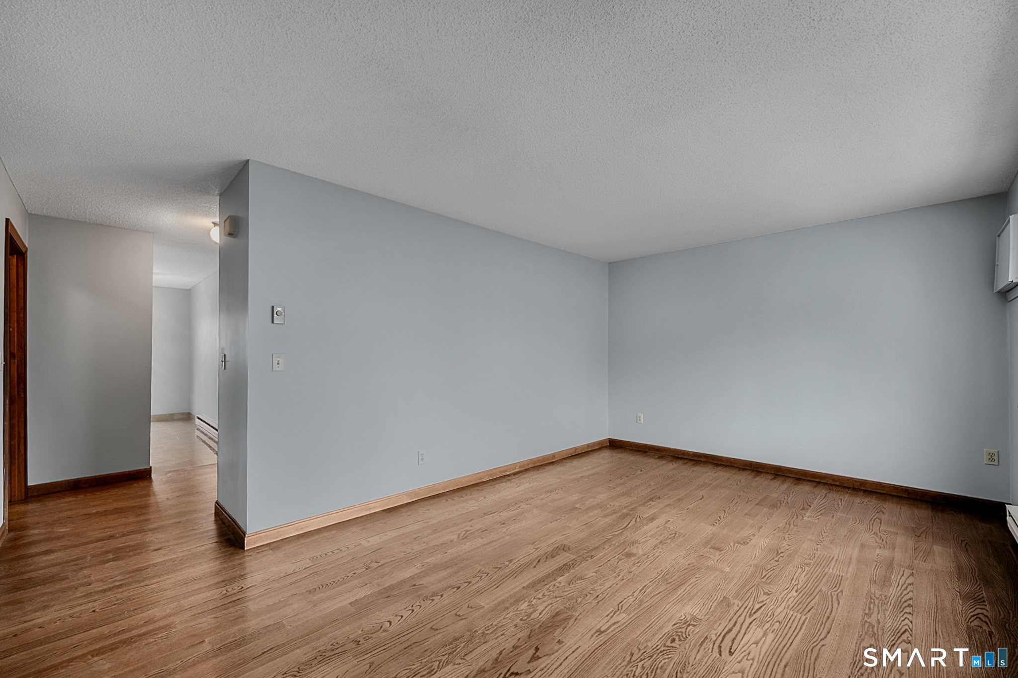 81 Chipman Street, Unit 13 Waterbury, CT 06708 - Photo 9 of 11 a view of an empty room with wooden floor