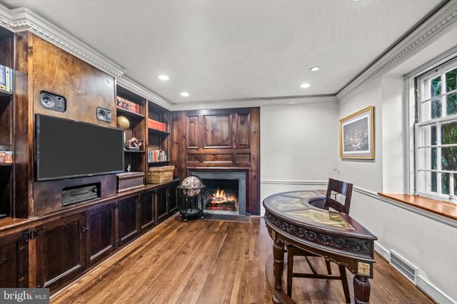 a kitchen with granite countertop a stove and a wooden floor