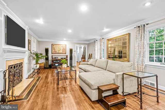 a living room with furniture fireplace and flat screen tv